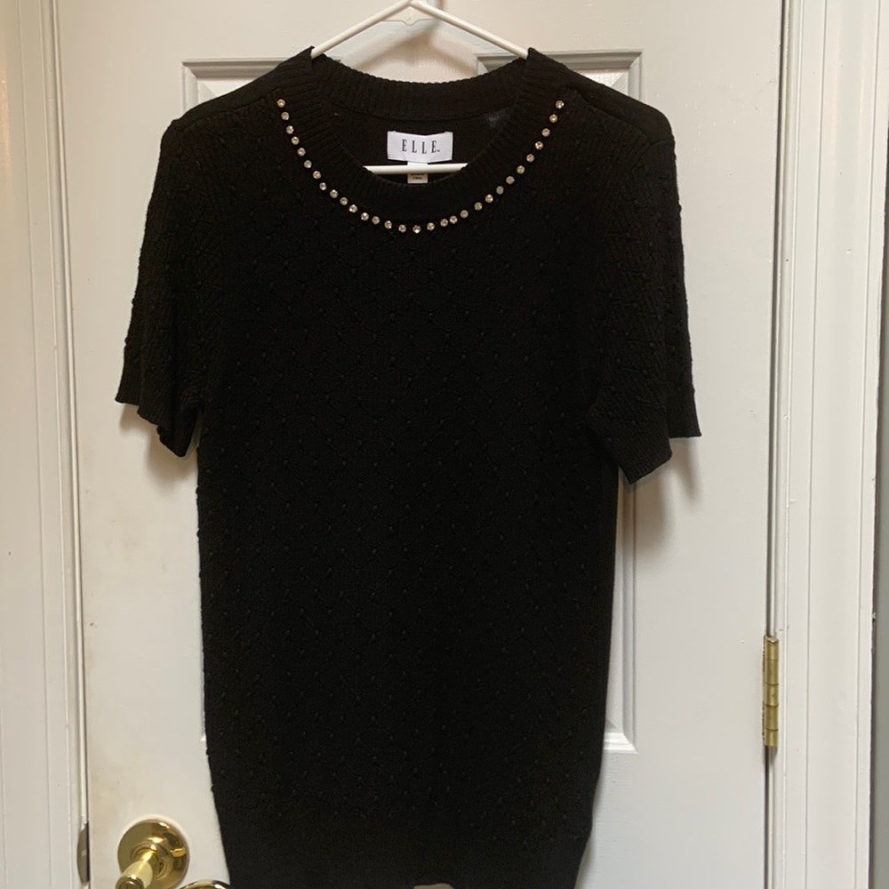 Sophisticated top with bejeweled neckline, perfect for work